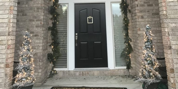 Front door decorated with holiday decor by Bud Branch and Blossom